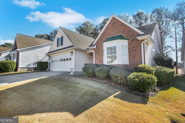 view of front property featuring a front yard and a garage