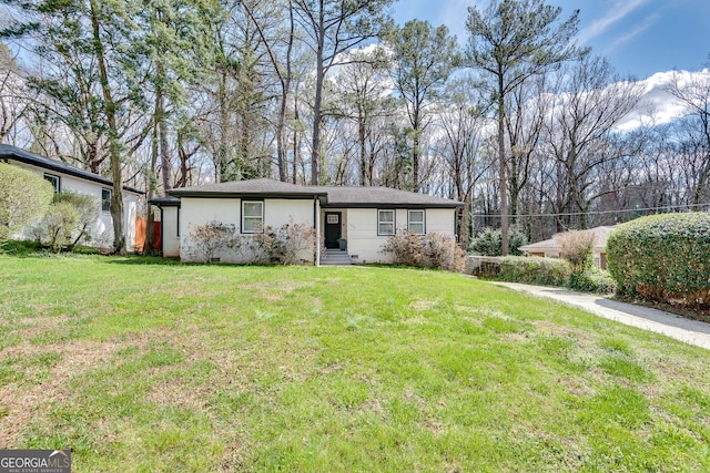 ranch-style home with a front lawn