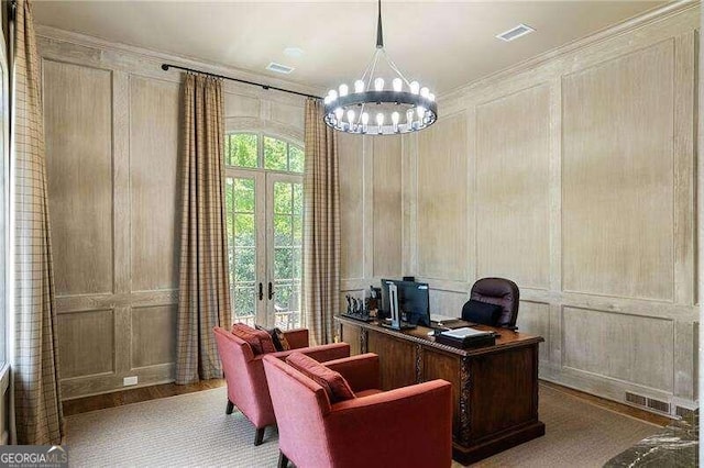 office with french doors, wooden walls, an inviting chandelier, and crown molding