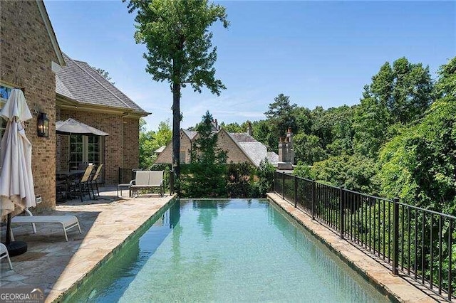 view of pool featuring a patio area