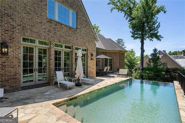 view of pool featuring french doors and a patio