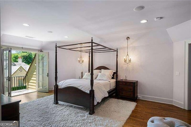 bedroom with access to outside and dark hardwood / wood-style floors