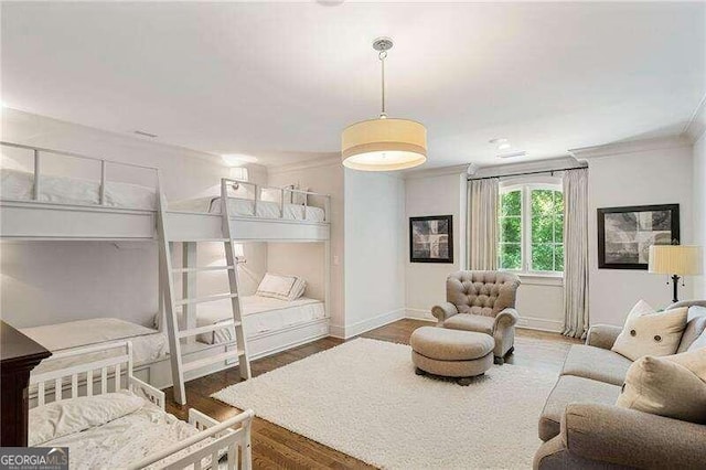 bedroom with ornamental molding and dark wood-type flooring