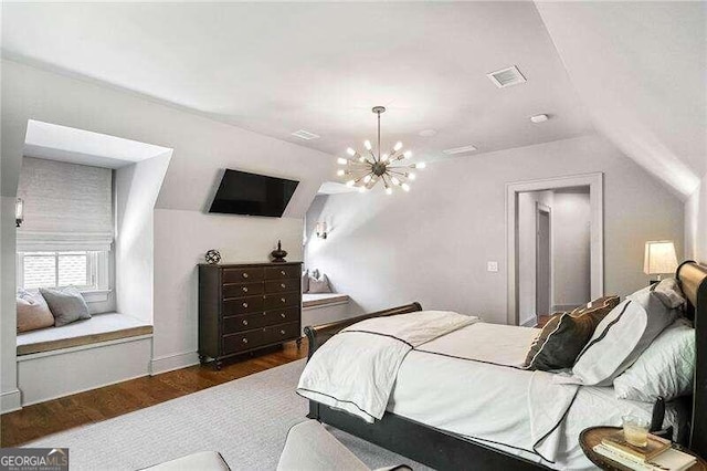 bedroom featuring dark hardwood / wood-style flooring, vaulted ceiling, and a notable chandelier