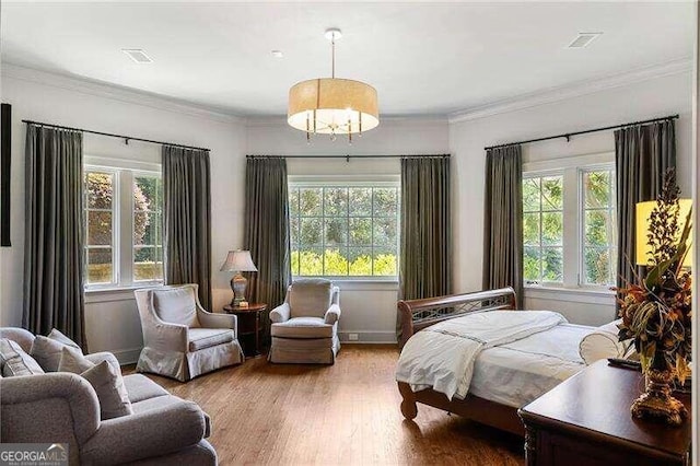 bedroom featuring hardwood / wood-style flooring and ornamental molding