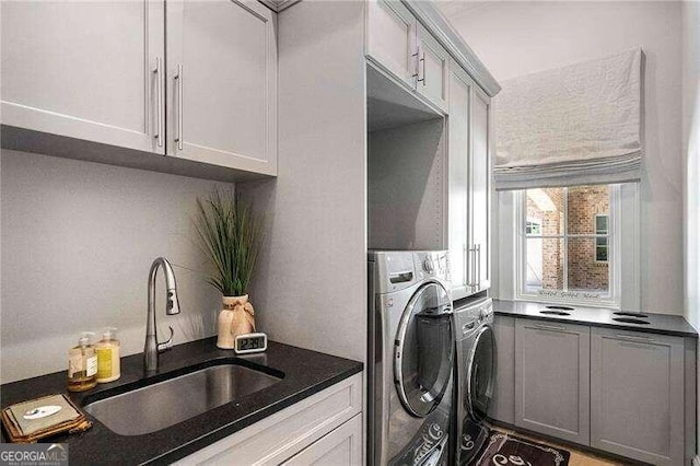 laundry area with washer and clothes dryer and sink