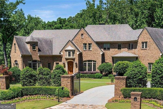 tudor house featuring a front yard