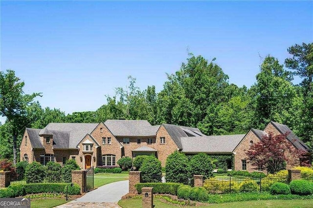 tudor home with a front lawn