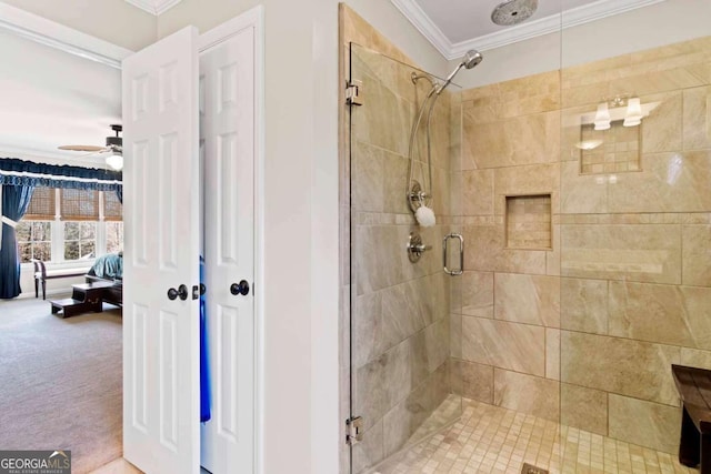 bathroom with ceiling fan, an enclosed shower, and ornamental molding