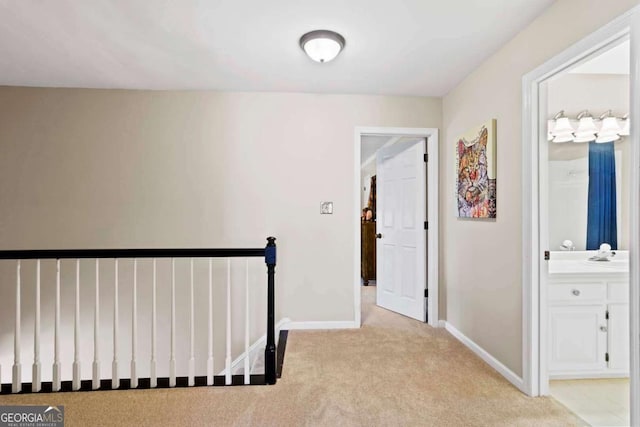 corridor featuring light colored carpet