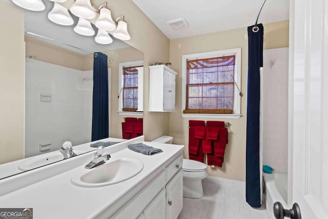 full bathroom with tile patterned flooring, shower / bath combination with curtain, vanity, and toilet