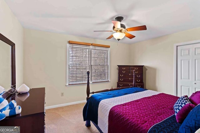 bedroom featuring light carpet, a closet, and ceiling fan