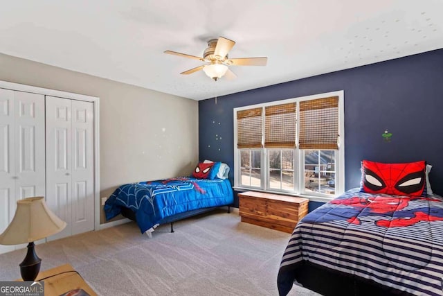 bedroom with ceiling fan, carpet floors, and a closet