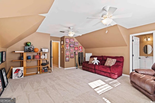 living room featuring ceiling fan, lofted ceiling, and light carpet