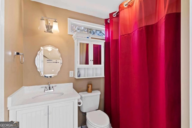 bathroom featuring vanity and toilet