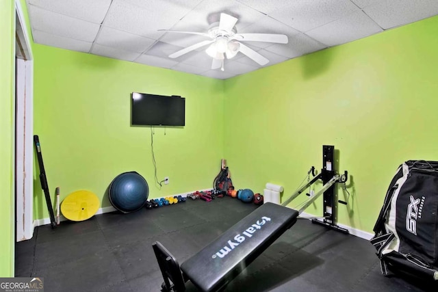 exercise area with a drop ceiling and ceiling fan