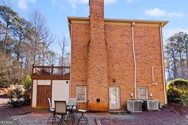 rear view of property featuring central AC unit and a patio area