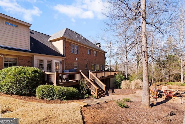 back of property featuring a deck