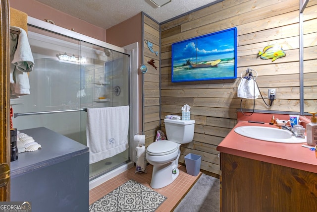 bathroom featuring walk in shower, tile patterned flooring, a textured ceiling, wooden walls, and vanity