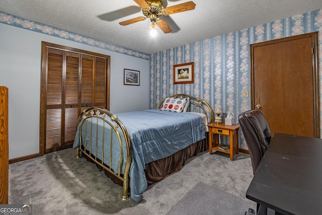 carpeted bedroom featuring a textured ceiling, a closet, and ceiling fan