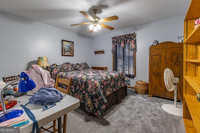 carpeted bedroom featuring a textured ceiling and ceiling fan