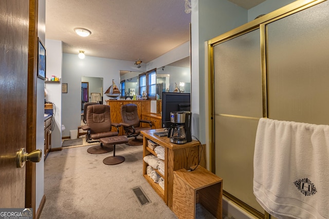 office space featuring carpet and a textured ceiling