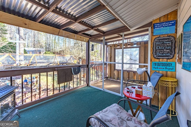 sunroom / solarium featuring vaulted ceiling