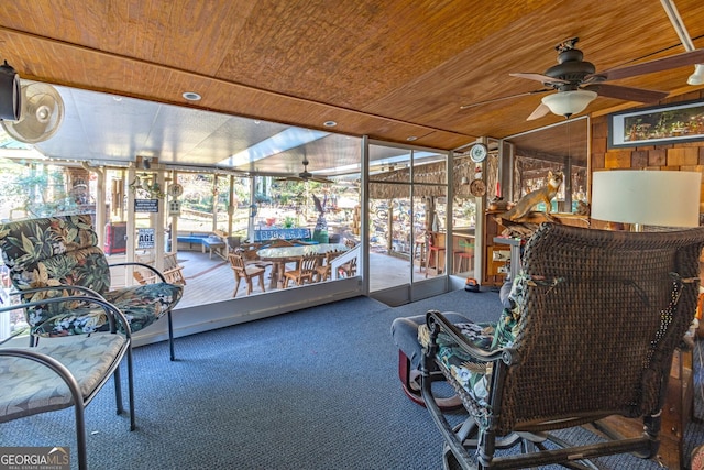 sunroom / solarium featuring ceiling fan and wooden ceiling