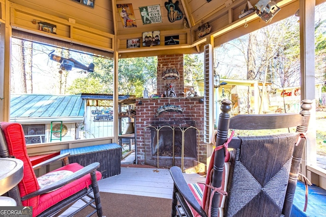 sunroom / solarium with an outdoor brick fireplace