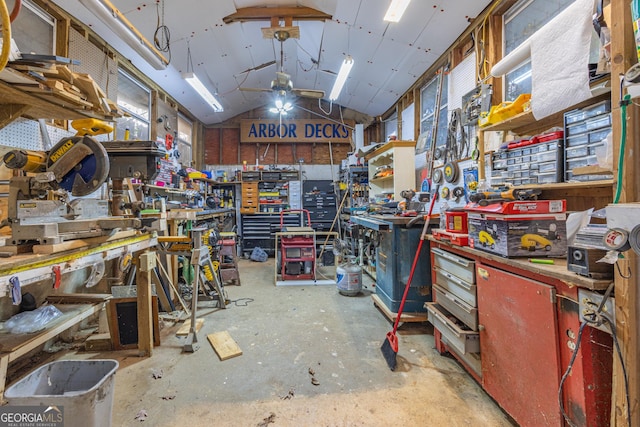 miscellaneous room featuring a workshop area, concrete floors, and vaulted ceiling