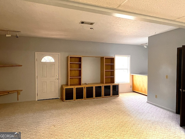 unfurnished living room featuring carpet