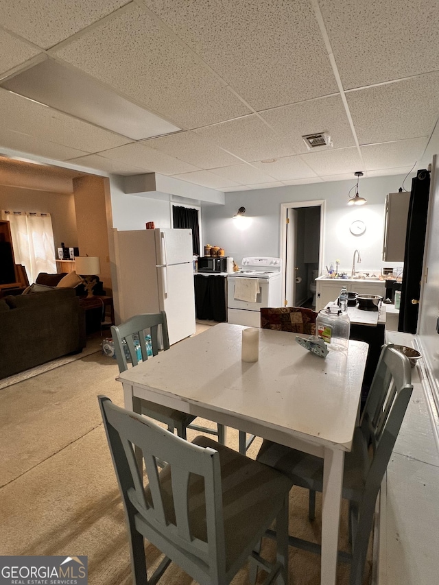 dining room featuring a drop ceiling