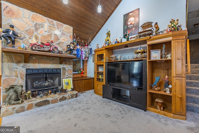 carpeted living room featuring a fireplace, wooden ceiling, and vaulted ceiling