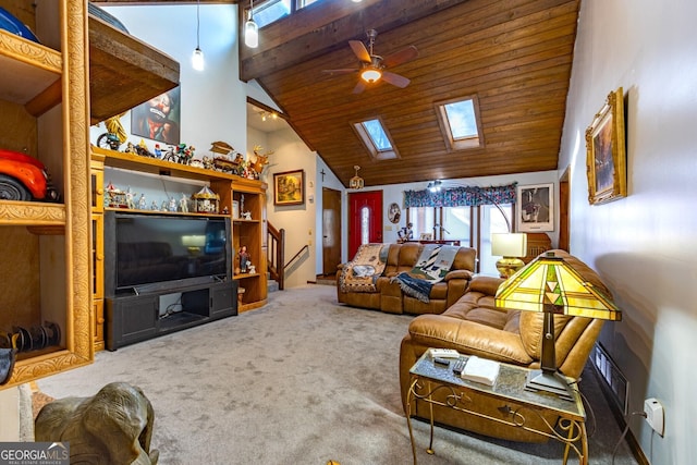 carpeted living room with a skylight, ceiling fan, high vaulted ceiling, and a wealth of natural light