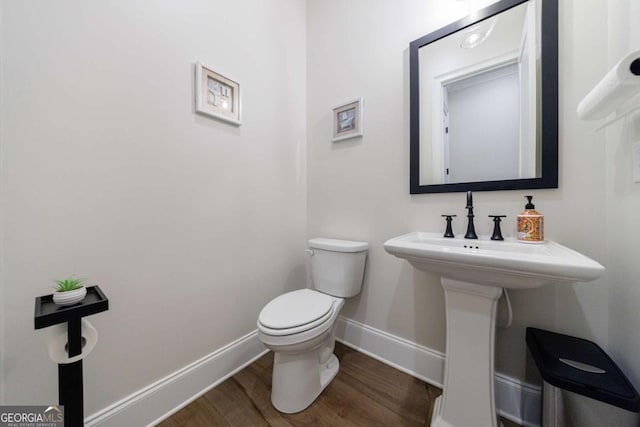 bathroom featuring hardwood / wood-style floors and toilet