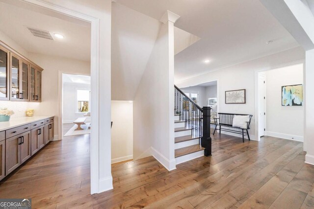 living room with coffered ceiling, hardwood / wood-style flooring, a fireplace, and beamed ceiling