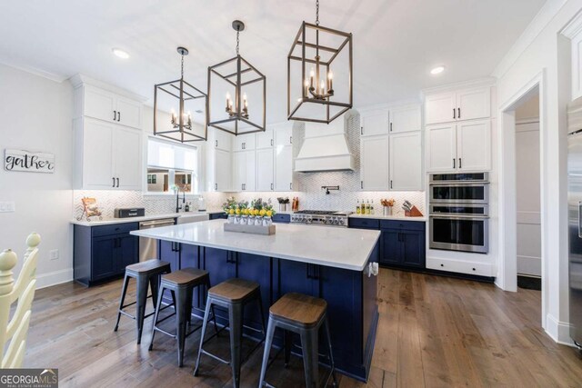 living room with hardwood / wood-style flooring, coffered ceiling, and beamed ceiling