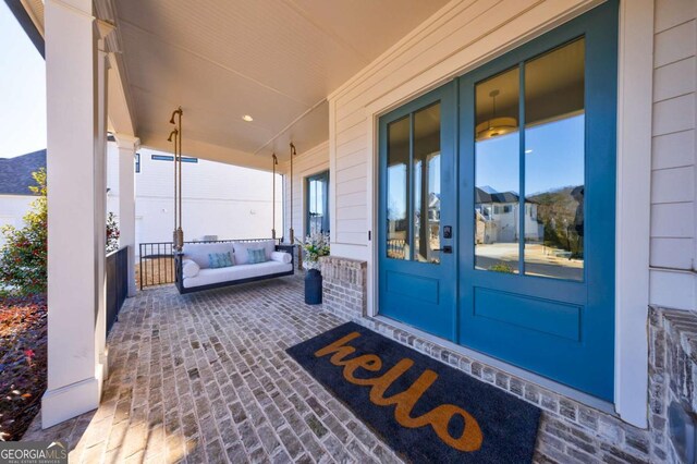 rear view of property featuring a yard, a fenced in pool, a patio area, and a balcony