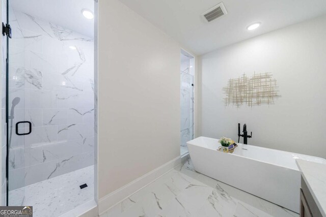 bathroom featuring vanity and shower with separate bathtub