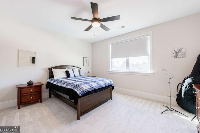 bedroom with light carpet and ceiling fan