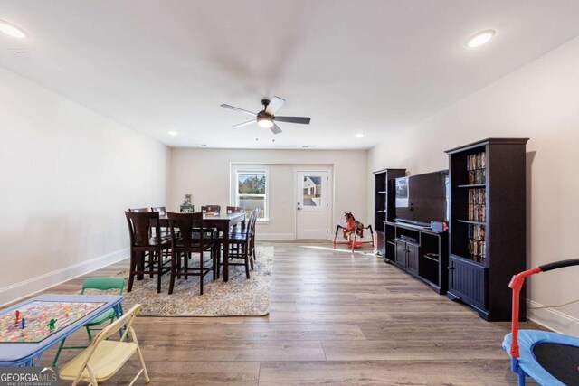 dining space featuring ceiling fan and wood-type flooring