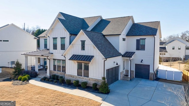 modern farmhouse featuring a garage and covered porch