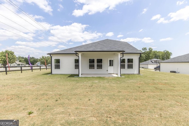 rear view of house featuring a yard and a patio area