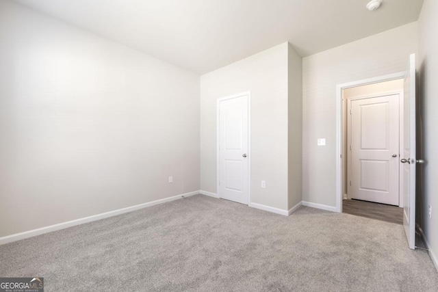 unfurnished bedroom featuring light carpet