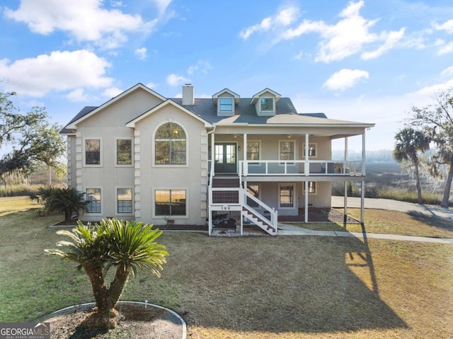 view of front of property featuring covered porch and a front lawn