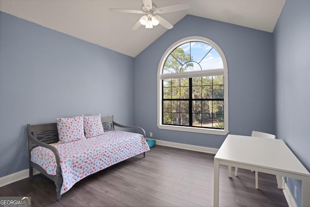 bedroom with ceiling fan, dark hardwood / wood-style floors, and lofted ceiling