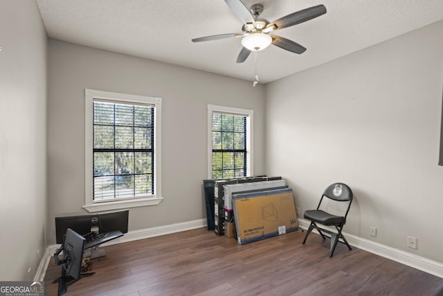 sitting room featuring a textured ceiling, ceiling fan, and dark hardwood / wood-style floors