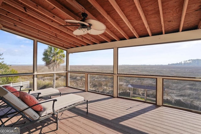 unfurnished sunroom featuring ceiling fan