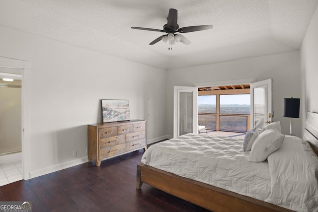 bedroom featuring a textured ceiling, ceiling fan, and dark wood-type flooring