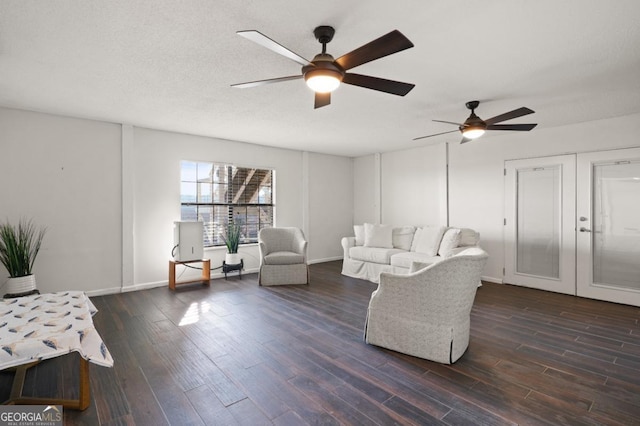 living room with dark hardwood / wood-style floors, ceiling fan, a textured ceiling, and french doors